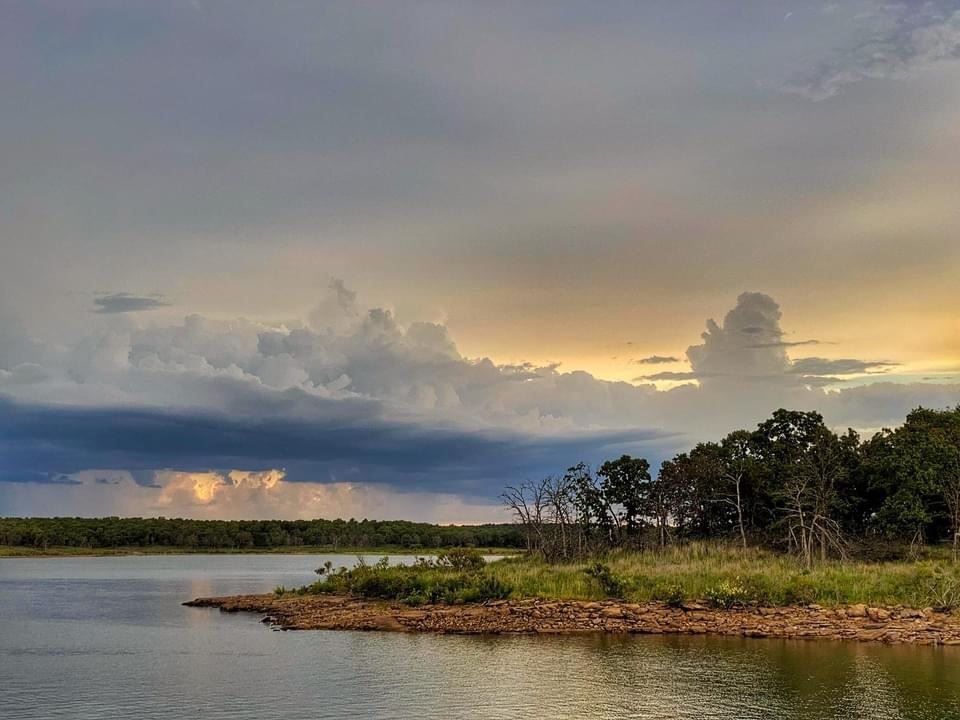 Shoreline at Skiatook Lake with clouds in the distance.