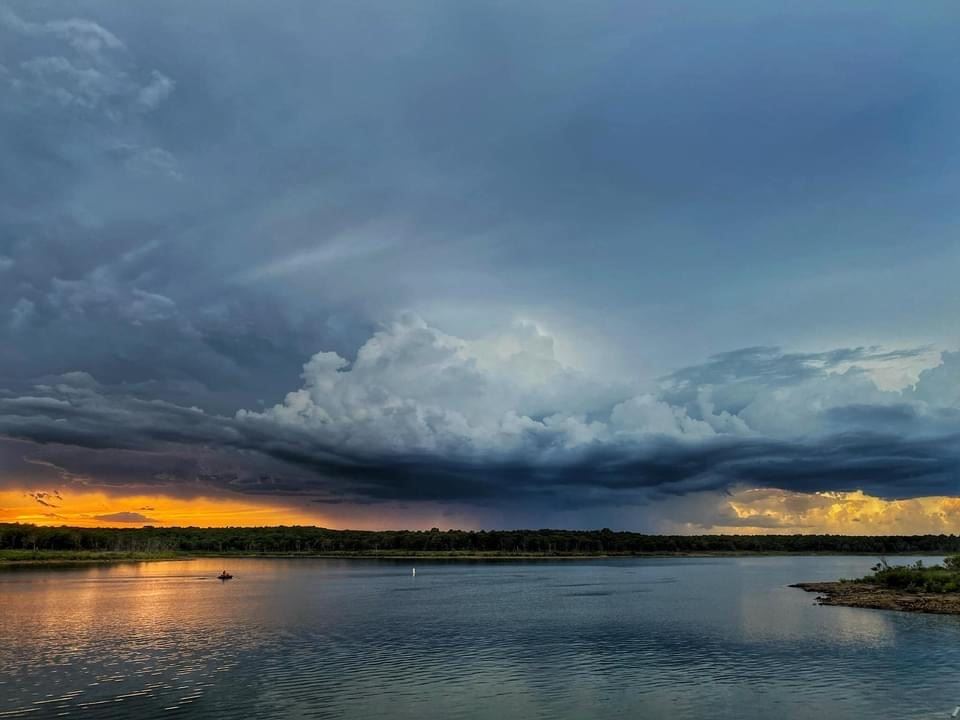 Wide view of clouds over the lake at sunset.