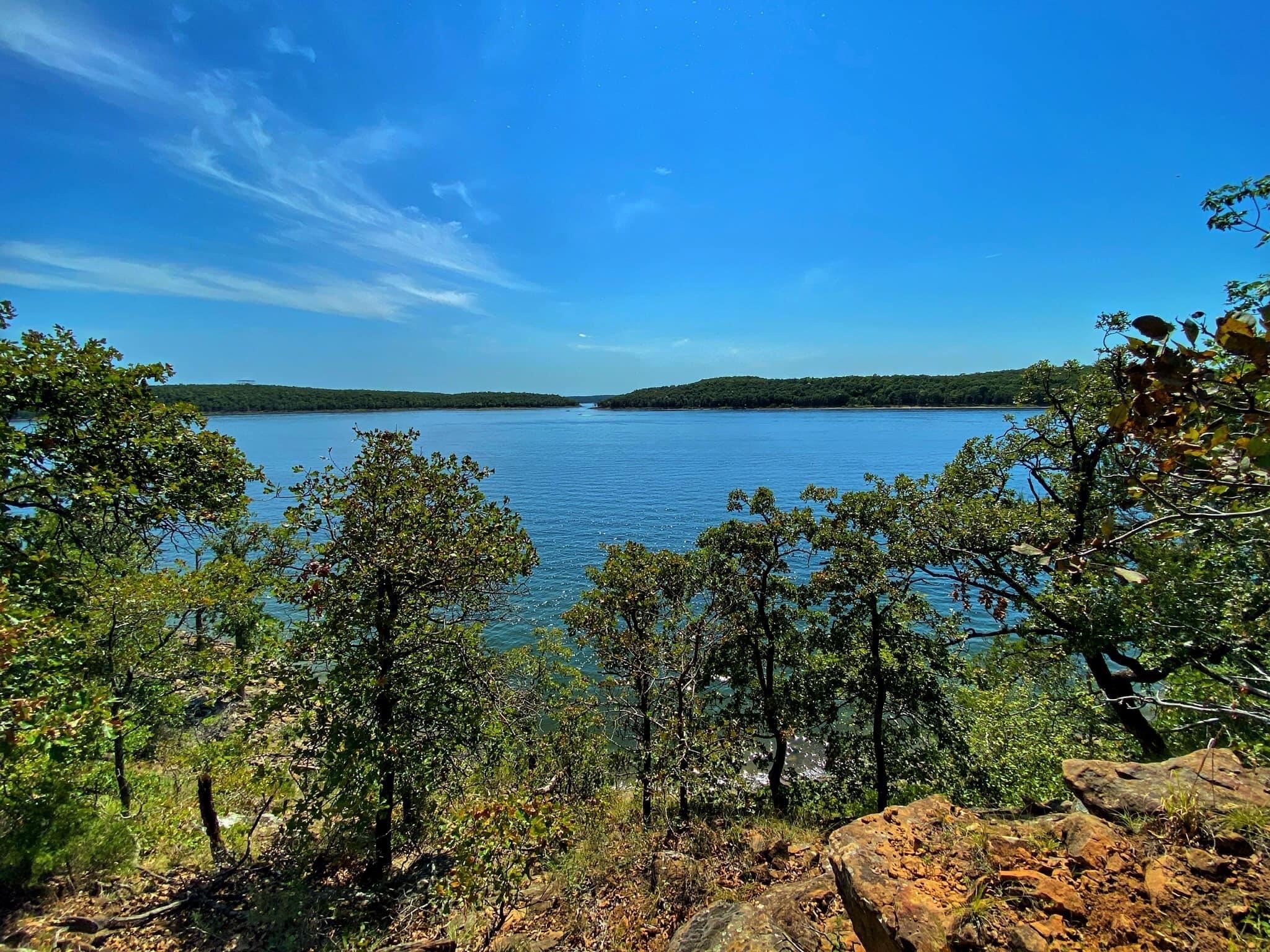 Wide view of Skiatook Lake through the trees.